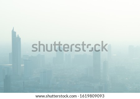 Concept of Pollution PM2.5 Unhealthy air pollution dust. Toxic haze in the city. Photos in the capital on a skyscraper. Royalty-Free Stock Photo #1619809093