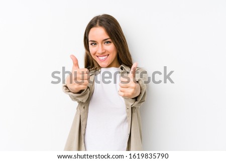 Young caucasian woman  isolated with thumbs ups, cheers about something, support and respect concept.