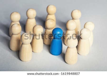 Leader concept. Wooden figures on grey background