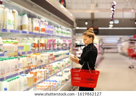 Woman choosing a dairy products at supermarket	 Royalty-Free Stock Photo #1619862127