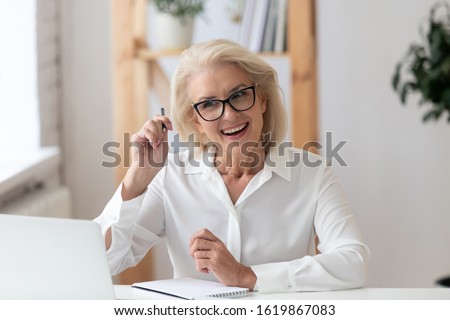 Aged woman company owner interviewing applicant at distant job interview, tutor teaches learner distantly. Businesswoman talk with client looks at pc screen, videoconferencing, video telephony concept Royalty-Free Stock Photo #1619867083