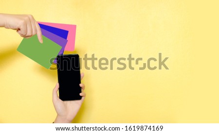 web banner internet of thing for life from group of passbook and mobile phone in beauty woman hand acting for internet banking Transaction with clipping path and copy space on yellow background