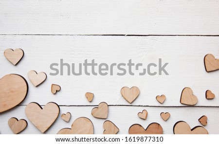 A beautiful background with  lot of wooden hearts on the white table