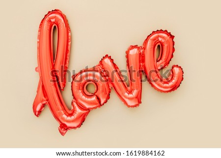 Red Foil Balloons in the shape of the word "Love". Love concept. Holiday, celebration. Valentine's Day or wedding/bachelorette party decoration.  