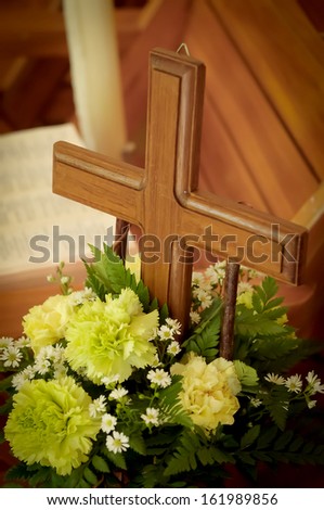 wood cross with beautiful green flowers