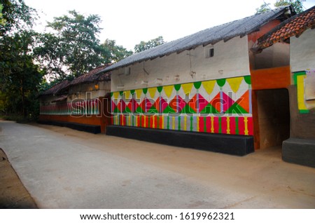 tribal village people colored there outside wall of house looking vintage and beautiful enriched with color and texture , Purulia India with intentional focus , noise , artifacts , grain