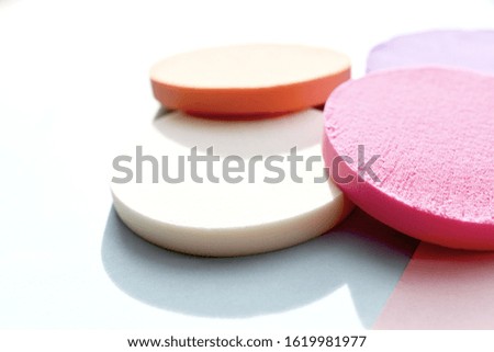 Cosmetic sponges are colored on a white background. Copy space.