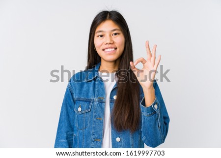 Young asian woman cheerful and confident showing ok gesture.