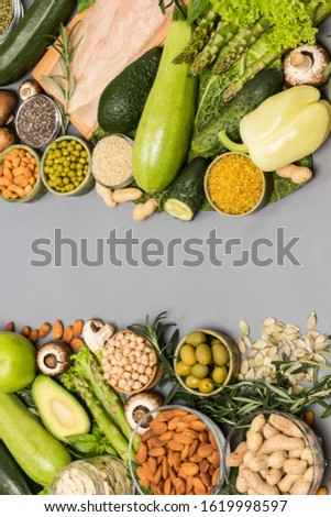 Balanced food set, green vegetables, seeds nuts, chicken meat. Diet  food. Flat lay, gray background. Copy space 
