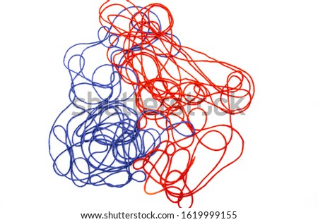 bright red and blue tangled threads on a white background