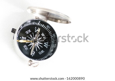 Small pocket compass isolated on white background