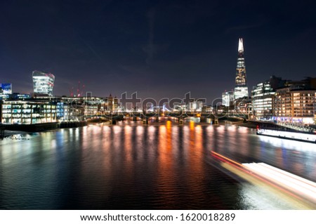 River Thames at night, The Shard, London Bridge and Tower bridge in the background.