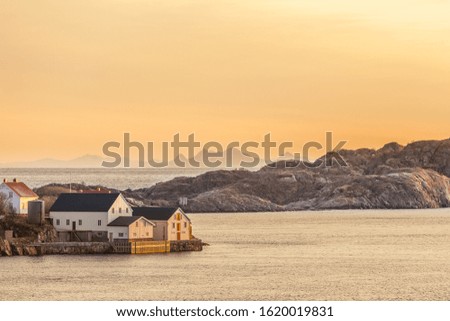 wood house with dramatic sunset in background in lofoten, Norway. Amazing landscape. long shutter speed. selective focus