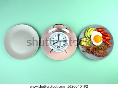 Intermittent fasting concept with empty colorful plates. Time to lose weight , eating control or time to diet concept. Royalty-Free Stock Photo #1620040492