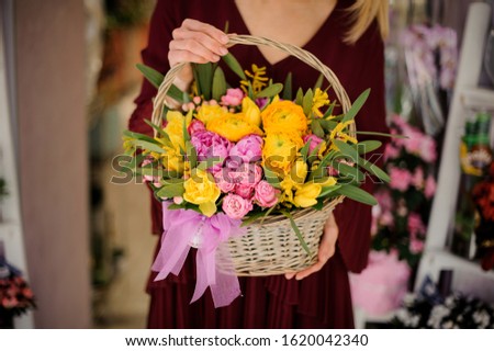 Close-up of colorful peonies and roses in cute basket