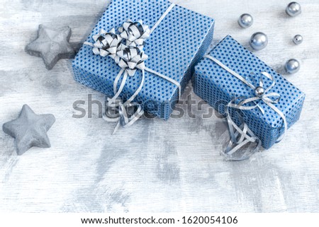 Blue gift box on a light wooden background . Valentine's day, holiday and gifts. Back background.