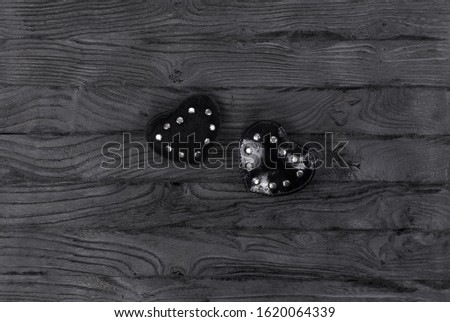 black hearts for valentines day on a black wooden table