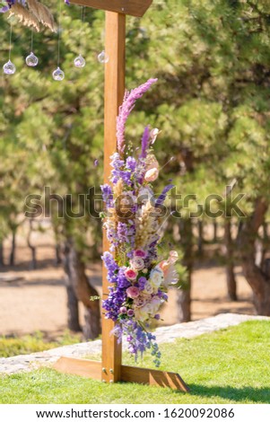Decorative decoration of the wedding arch with fresh flowers. Holding a wedding ceremony in the open. Decoration details.