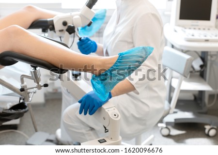 A gynecologist is examined by a patient who is sitting in a gynecological chair. Examination by a gynecologist. Female health concept. Royalty-Free Stock Photo #1620096676