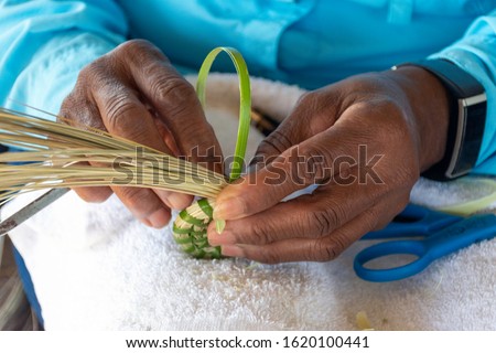 A descendent of slaves, this woman Gullah Geechee master sweetgrass basket weaver creates traditional cultural art on Sapelo Island, Georgia. Royalty-Free Stock Photo #1620100441