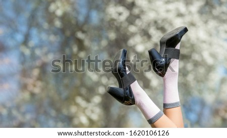Young woman legs in spring or summer park