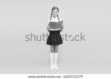 reading literacy. happy girl study hard with notebook. literature lesson. childrens literature. back to school. Pupil at book store or library. small girl child with book. reading and writing.