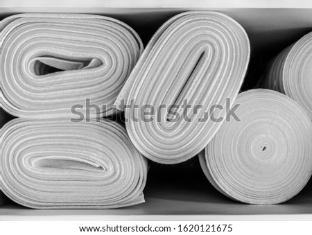 White foam in rolls close-up, building materials, yoga mat, insulation boards, texture from soundproof sponge, polystyrene