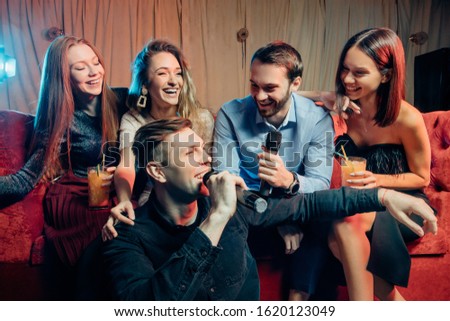 young caucasian people in trendy modern karaoke bar. Party makers. Celebrating birthday, holidays concept