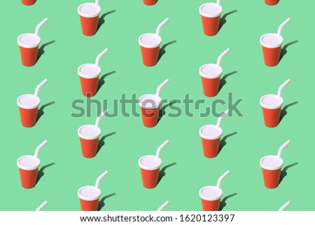 Paper cup with drinking straw carbonated soft drink pattern on pastel green background minimal creative concept.