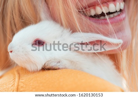 Alice in Wonderland. Rabbit on smile woman mouth background. Easter Bunny
