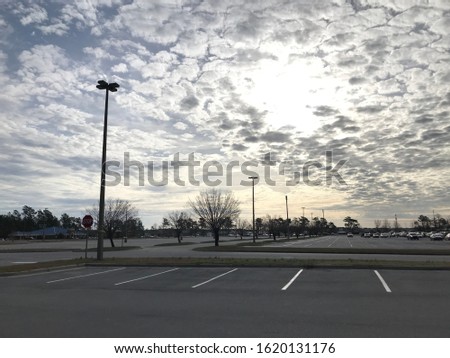 Nice clouds, parking lot in urban area.