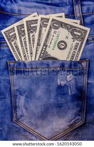 American one dollar banknotes in pocket of blue jeans
