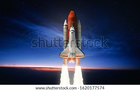 Space shuttle launch in the open space over the Earth. Sky and clouds under space ship. Elements of this image furnished by NASA