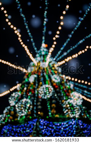 Kremenchuk / Ukraine - December 30 2019: Festive Christmas tree and people celebrating having fun at the Christmas market in the city of Kremenchug, Ukraine