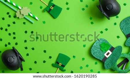 St Patricks Day frame of leprechaun hats, pots of gold, drinking straws, Patricks Day glasses on green background. Saint Patrick’s day party invitation card template, poster mockup, banner design