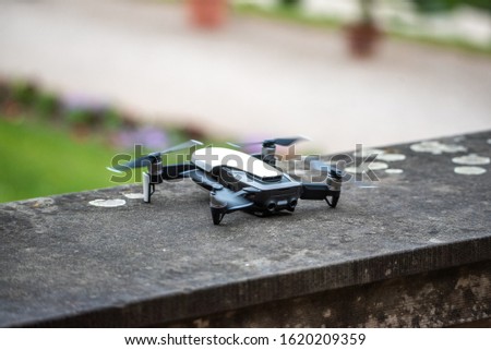 drone copter flying with digital camera.Drone with high resolution digital camera. Flying camera take a photo and video.The drone with professional camera takes pictures of park