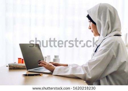 Muslim asian woman doctor and stethoscope working with laptop computer in hospital.healthcare and medicine