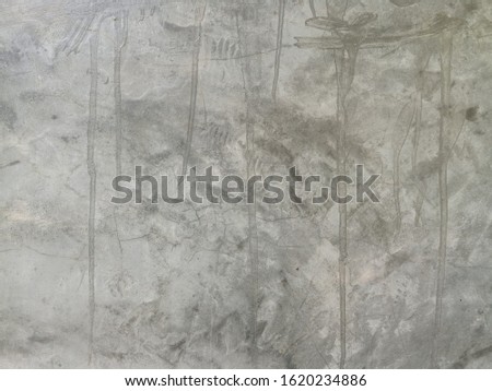 The background is made of gray concrete with patterns.