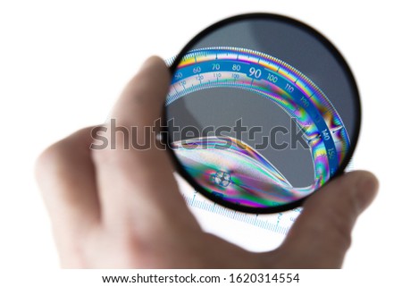 Transparent plastic protractor, photographed through a polarizing filter with a polarized light source.