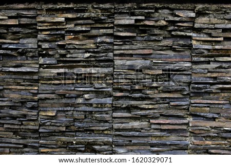 Layered stone wall texture background for design and decoration.