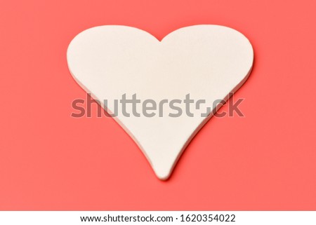 One white heart on a pink background. Valentines day. Holiday celebration