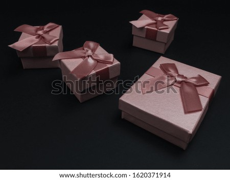 Online shopping, black friday composition. Gift boxes with bows on black background.