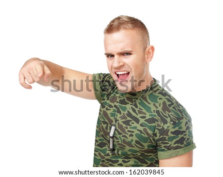 Loud scream of anger furious army soldier pointing towards camera isolated on white background
