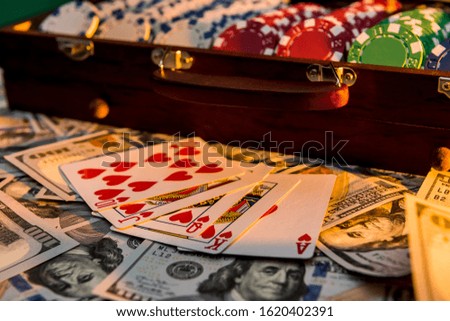 a grand casino super prize - a case full of chips, dollars and playing cards on a black background