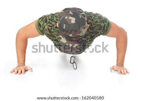 Young army soldier doing push up isolated on white background.Front view