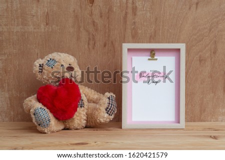 Mockup Picture frame and cute bear with red heart. Valentines Day Background concept with copy space. Mock up with photo frame and teddy bear with space for your picture or text