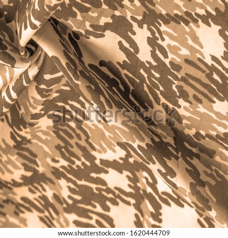 Background design texture, sandy sepia yellow silk fabric, abstraction, copyright print, military camouflage fleece fabric, your designs will allow you to be military,