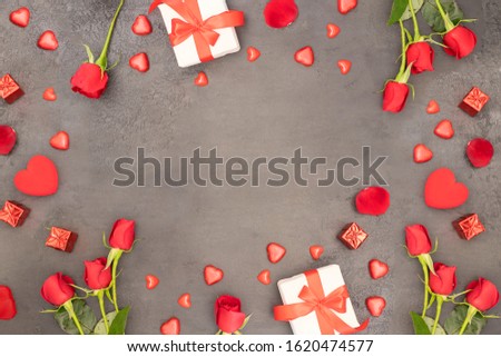 Saint Valentine’s Day background with Copy space. Red rose bouquet, gift box with ribbon bow and different red heart