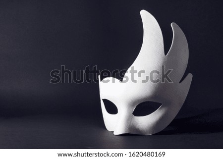 white carnival mask on a black background. concept of carnival, holiday, festival.
