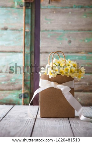 Mother's day. Narcissus flowers with card. Spring flowers
